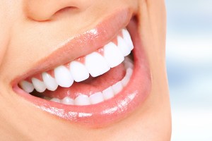 Dentist smiling with young patient wearing fairy wings in clinic